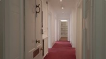 A hallway with red carpetDescription automatically generated