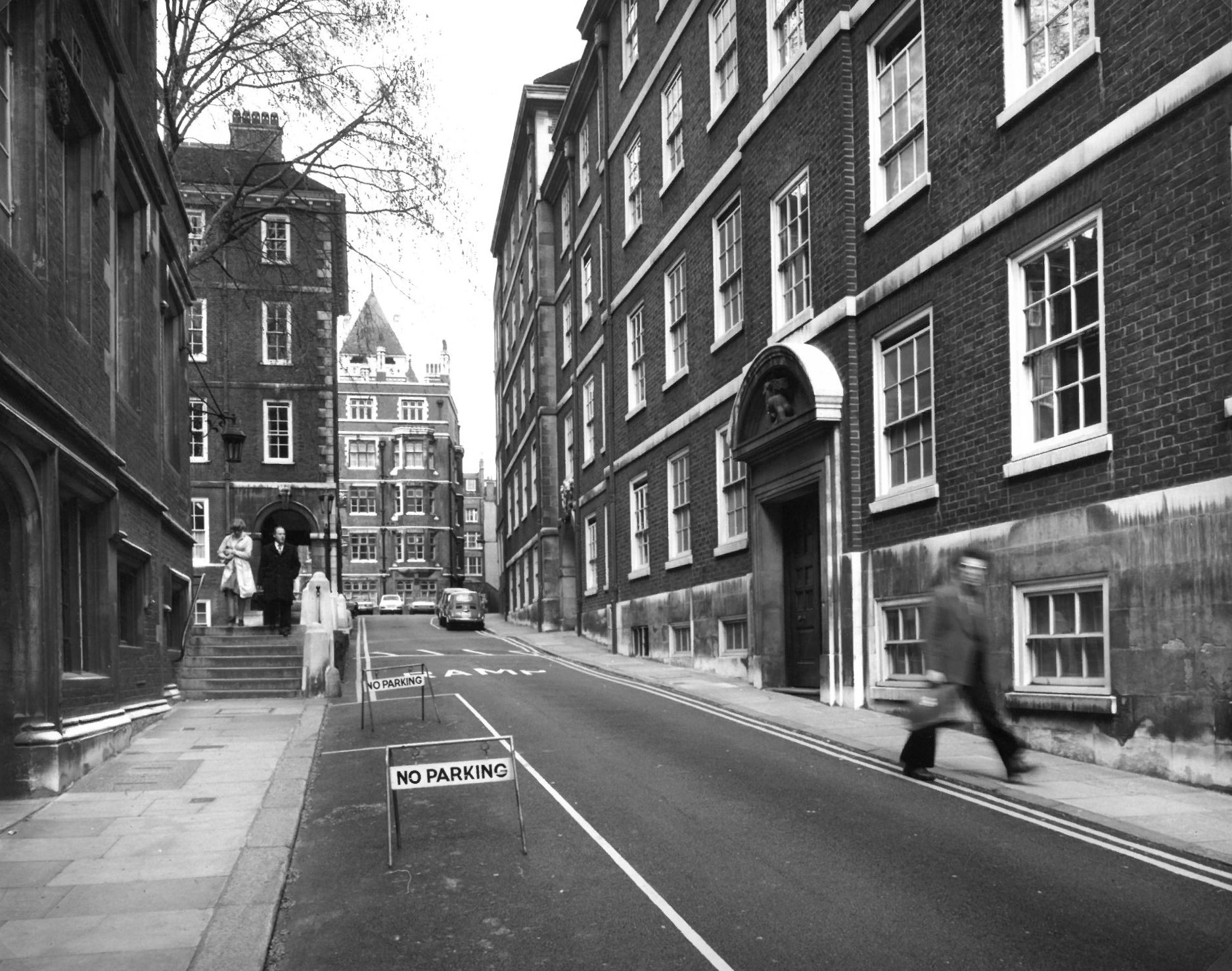 No Parking signs on Middle Temple Lane with cars in the distance