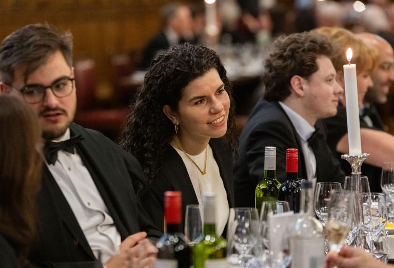 Guests engaging in conversation over a three-course meal